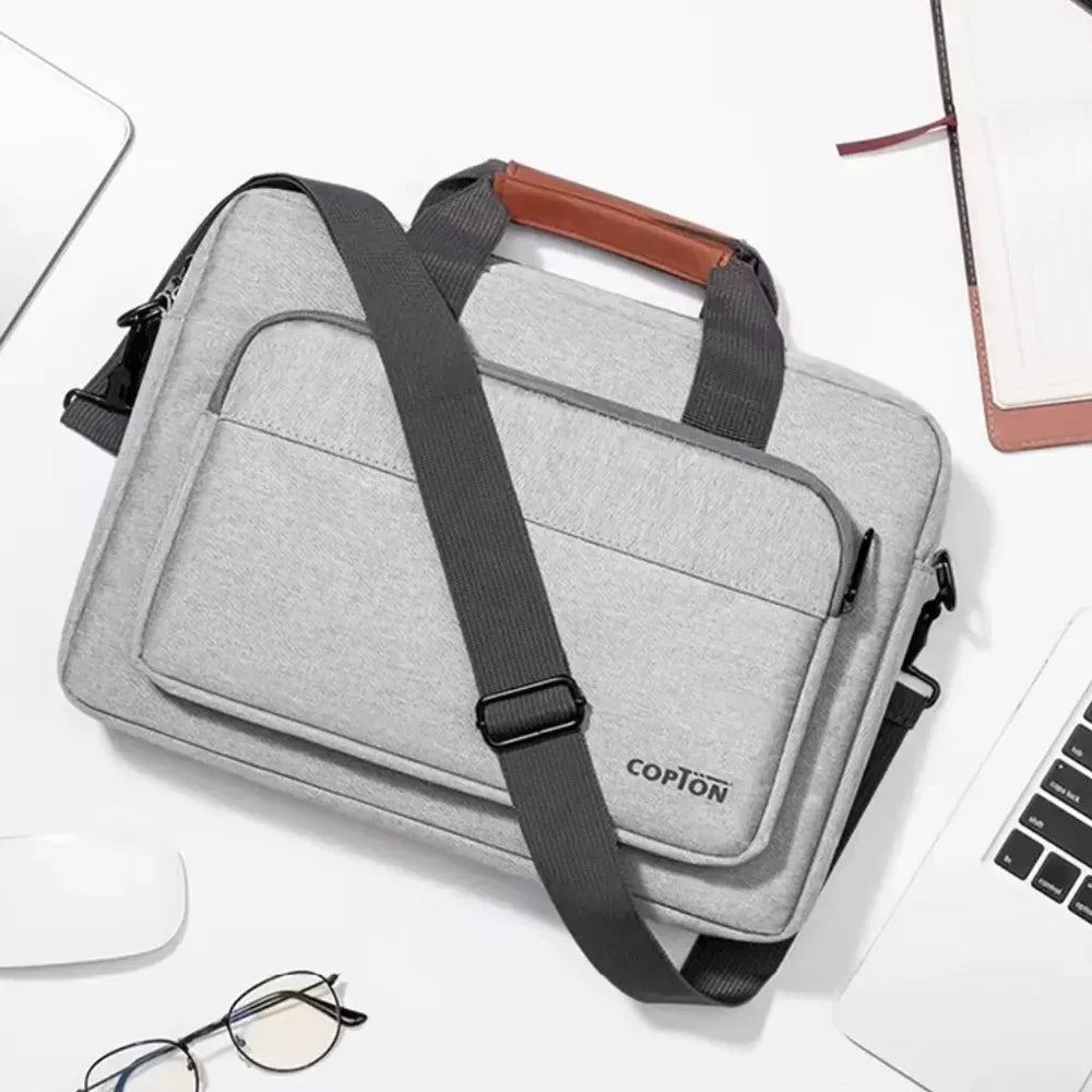 Lichtgrijze laptoptas met bruine accenten toont dat past een 15.6 inch laptop ook in een 16 inch tas met voldoende opbergruimte.