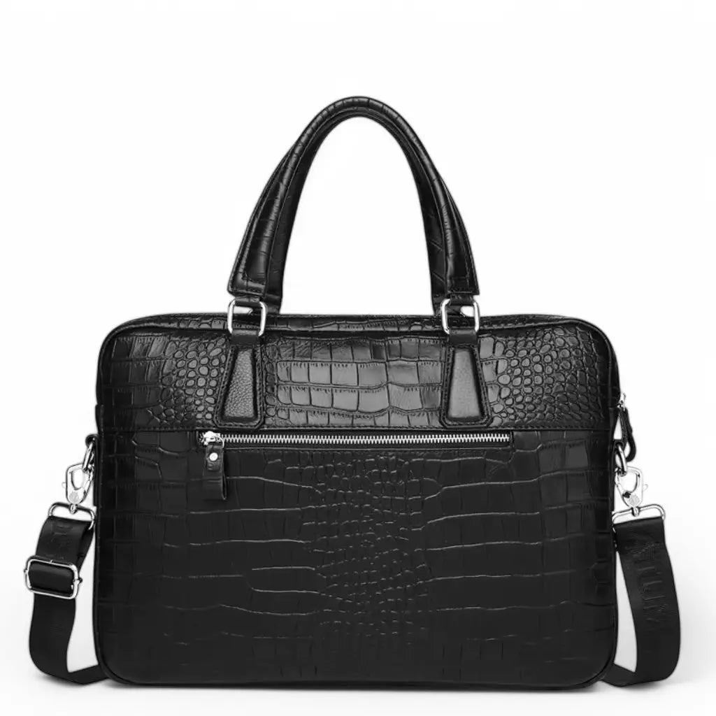 Vooraanzicht van de leren laptoptas dames kroko 15.6 inch met ritssluiting bovenaan. De zwarte krokodillenprint tas heeft een stijlvol design met zilveren metalen bevestigingen voor de handgrepen en schouderband, ideaal voor professioneel gebruik.