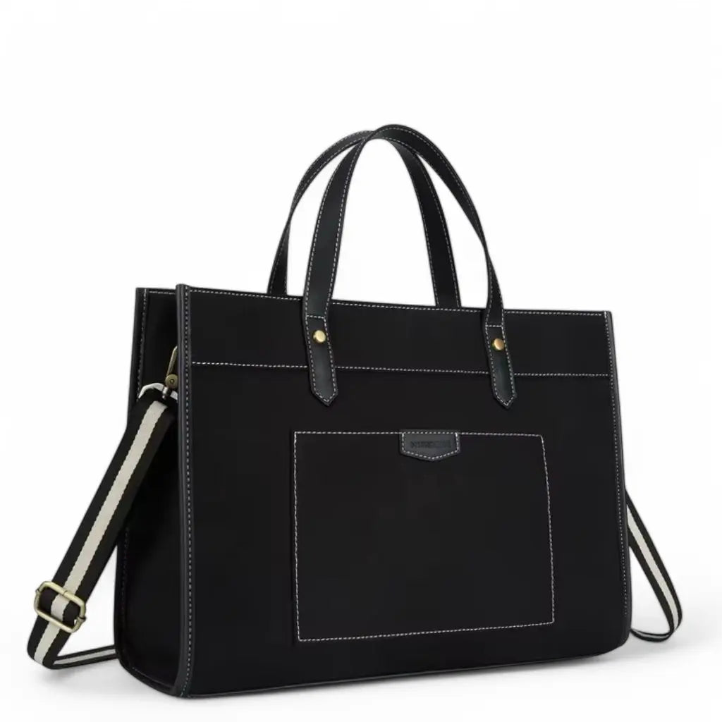 Een elegante zwarte canvas laptoptas voor dames van 15.6 inch, met stevige handvatten, afneembare schouderband en een praktisch voorvak met stiksels. De canvas laptoptas dames 15.6 inch is perfect voor dagelijks gebruik en zakelijke bijeenkomsten.