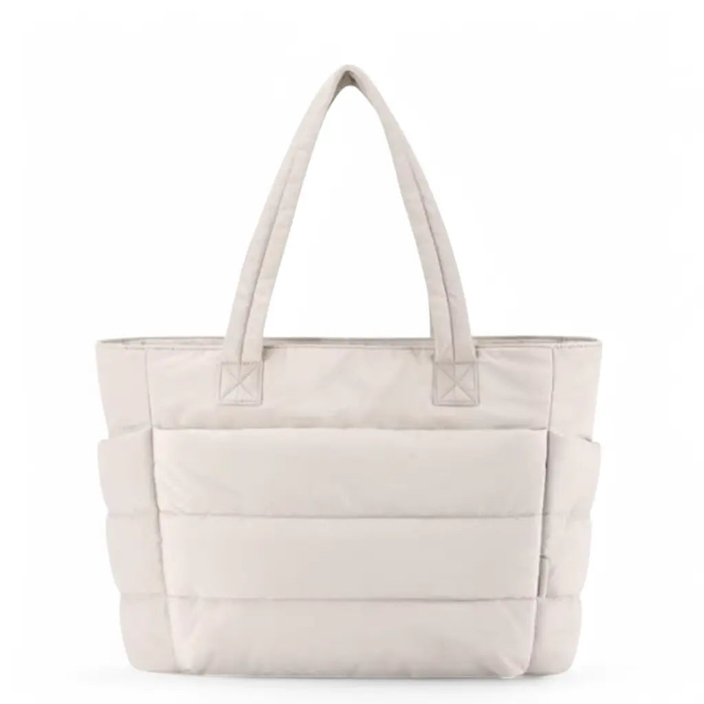 Beige uitvoering van de coole laptoptas dames 15.6 inch met dezelfde functionele horizontale quiltdetails en praktische handgrepen.