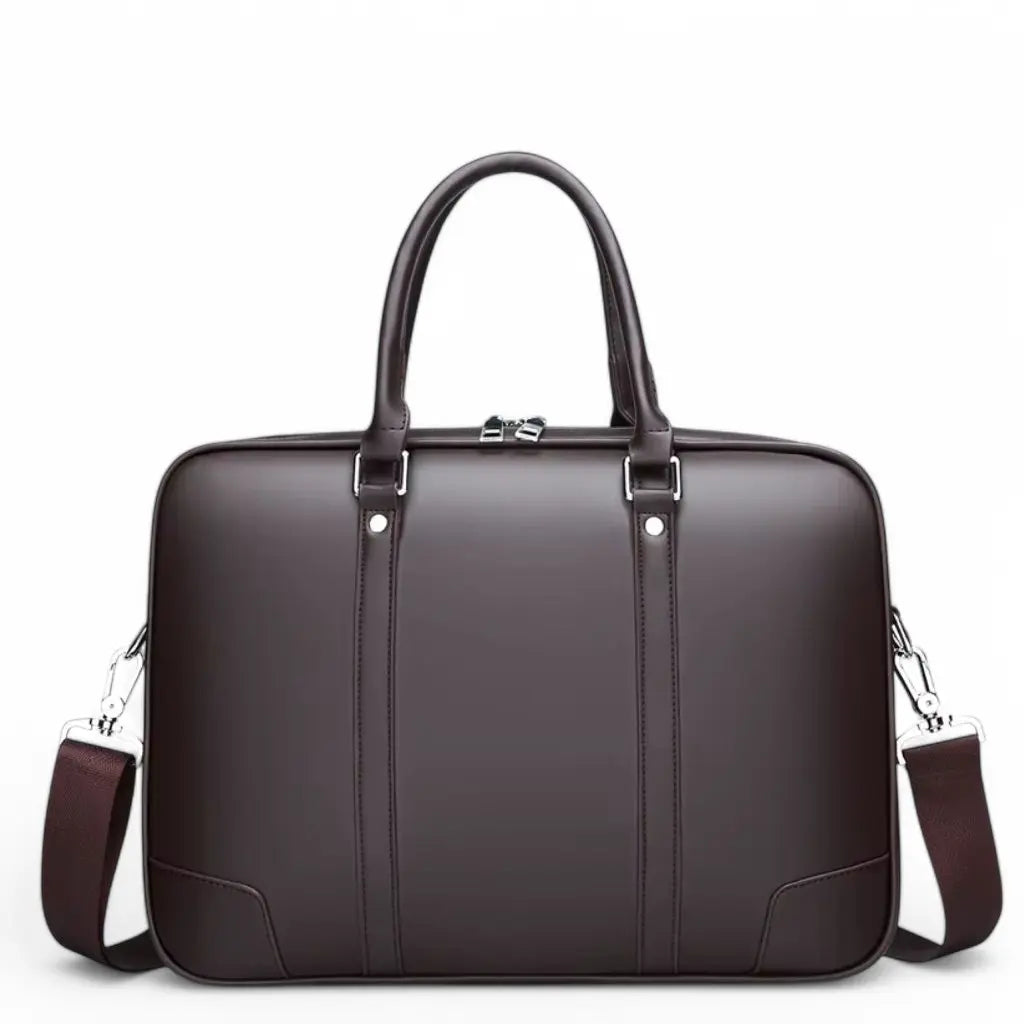 Stijlvolle design laptoptas heren 14 inch bruin gemaakt van hoogwaardig glad leer met metalen details. De elegante bruine laptoptas heeft stevige handgrepen, een ritssluiting aan de bovenkant en wordt geleverd met een verstelbare schouderriem voor veelzijdig draagcomfort.