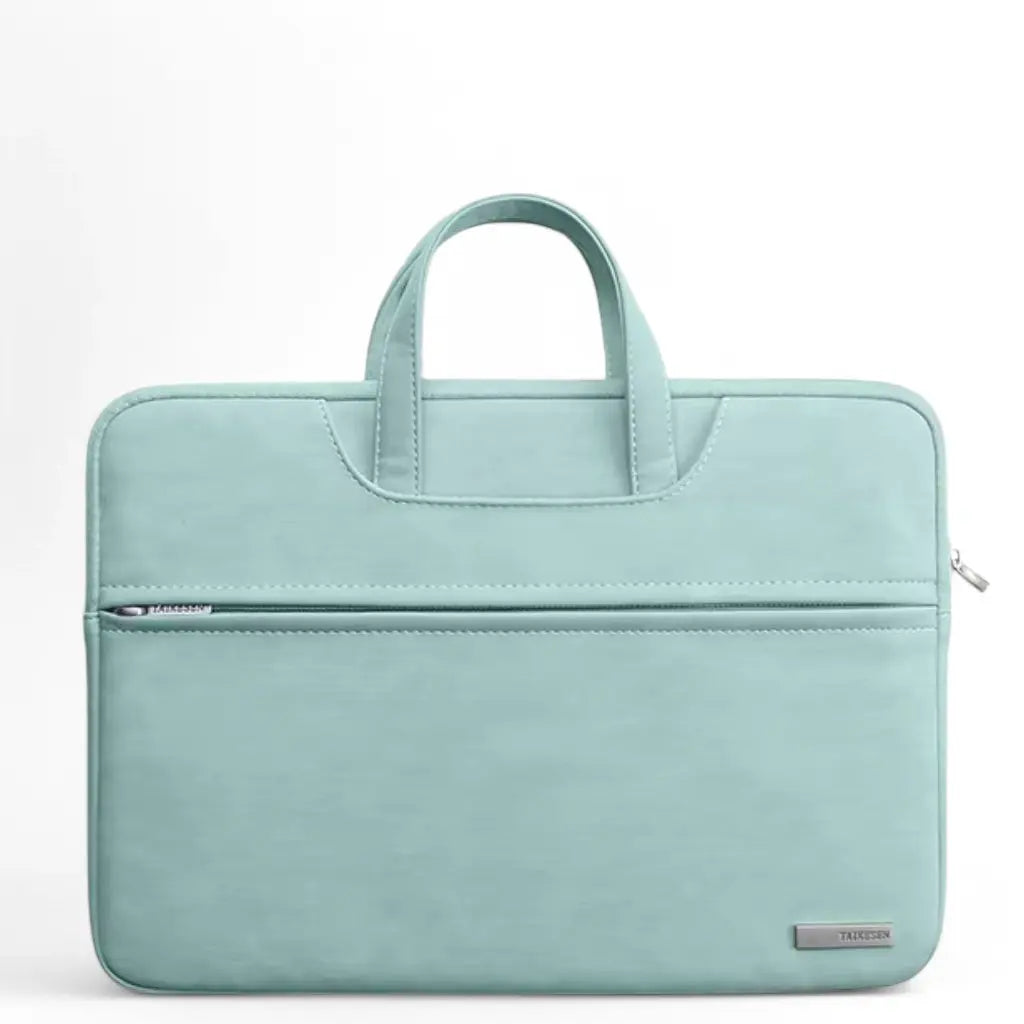 Stijlvolle laptoptas dames klein groen met handvaten en een voorvak met ritssluiting. De compacte, mintgroene tas heeft een minimalistisch design met subtiel TAIKESEN merklogo, perfect voor dagelijks gebruik of werk.