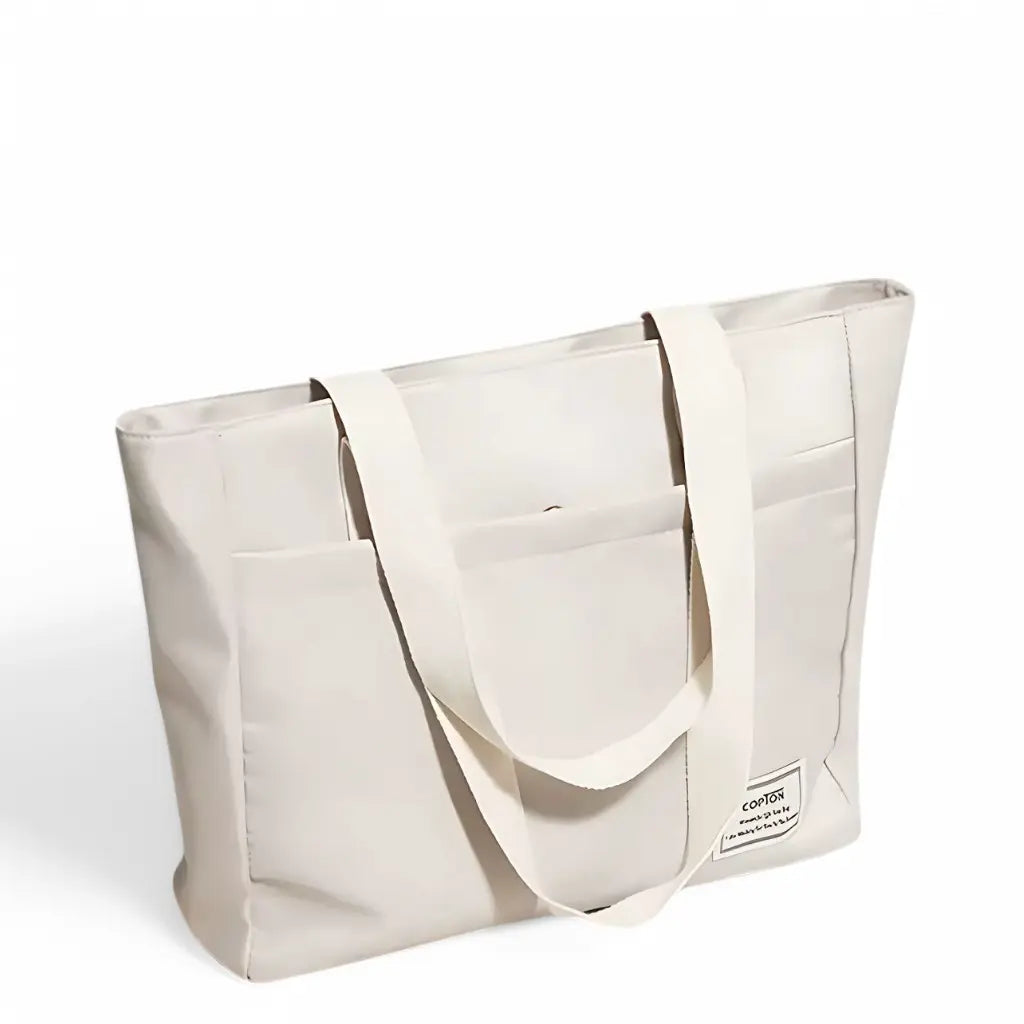 Crèmekleurige laptoptas fashion 14 inch met twee stevige handgrepen en ruime buitenvakken, perfect voor dagelijks gebruik.