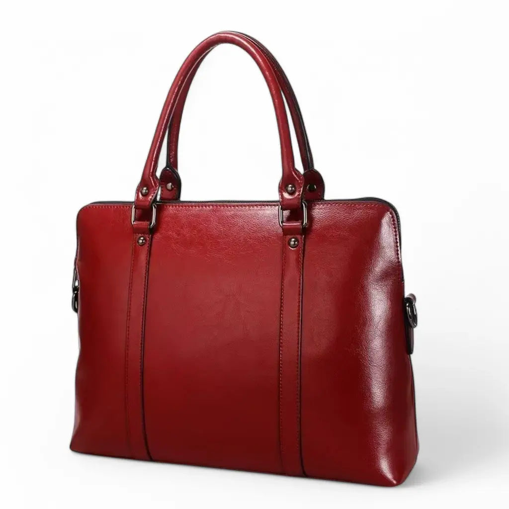 Voorkant van de leren laptoptas dames 14 inch rood met glanzend afgewerkt rundleer, verfijnde stiksels en ergonomische handgrepen, ideaal voor dagelijks gebruik op kantoor of tijdens zakenreizen.