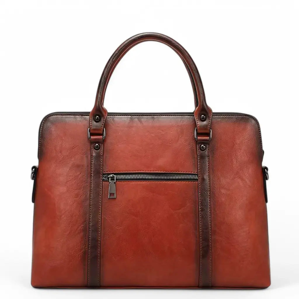 Leren vintage laptoptas dames 14 inch bruin, achterzijde met ritssluiting. De bruinrode laptoptas heeft stijlvolle handvatten, hoogwaardig leer met een vintage afwerking en metalen accessoires voor een professionele uitstraling.