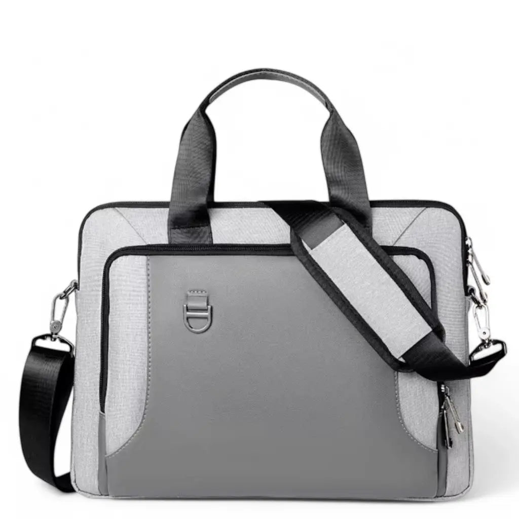 Elegante dikke laptoptas dames 17 inch grijs met middenpaneel in donkergrijs leer, lichtgrijze textielen buitenkant, zwarte handgrepen en verstelbare schouderriem met D-ring bevestiging op witte achtergrond.
