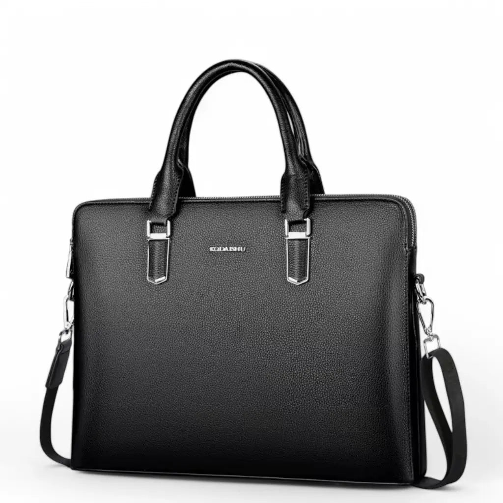 Een elegante nette laptoptas heren 14 inch zwart van KOMANSO met hoogwaardig lederachtig materiaal, stijlvolle handgrepen met zilverkleurige accenten en een afneembare schouderriem voor veelzijdig gebruik in zakelijke omgevingen.