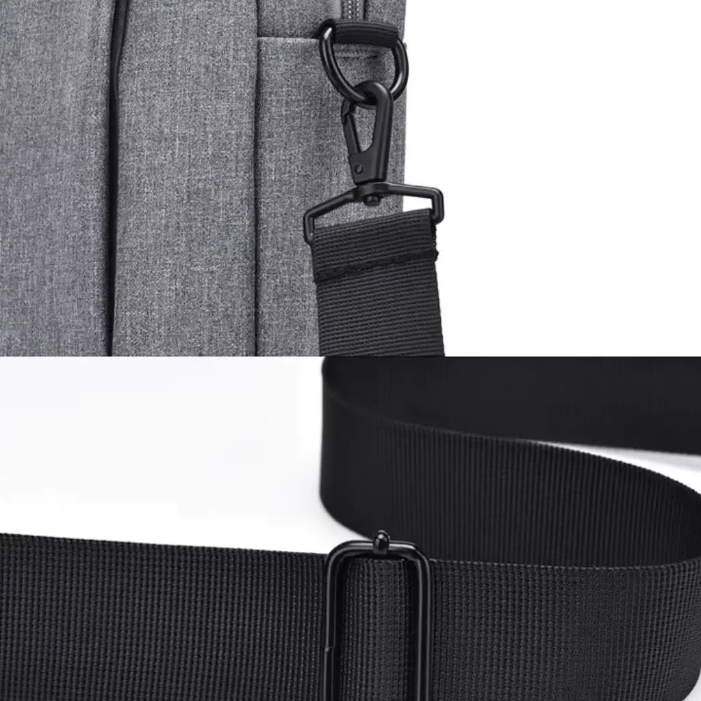 Close-up van de verstelbare schouderriem en bevestigingspunten van de laptoptas heren 13 inch grijs donkergrijs, met sterke metalen gespen en duurzaam nylonmateriaal.
